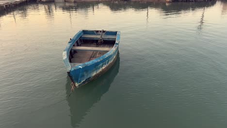 old blue fishing boat at dock