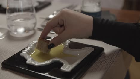 A-lady-tastes-olive-oil-in-a-restaurant