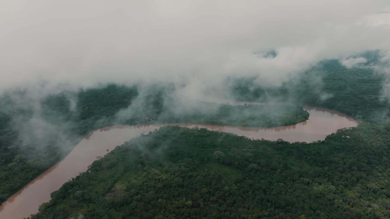 Murky River Between Dense Amazon Rainforest On Foggy Day