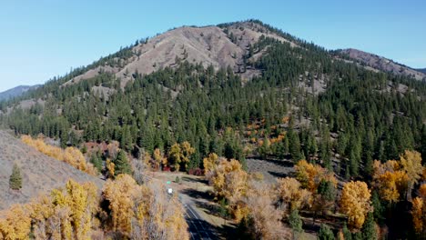 truck driving on a mountain road in the autumn forest in washington, usa