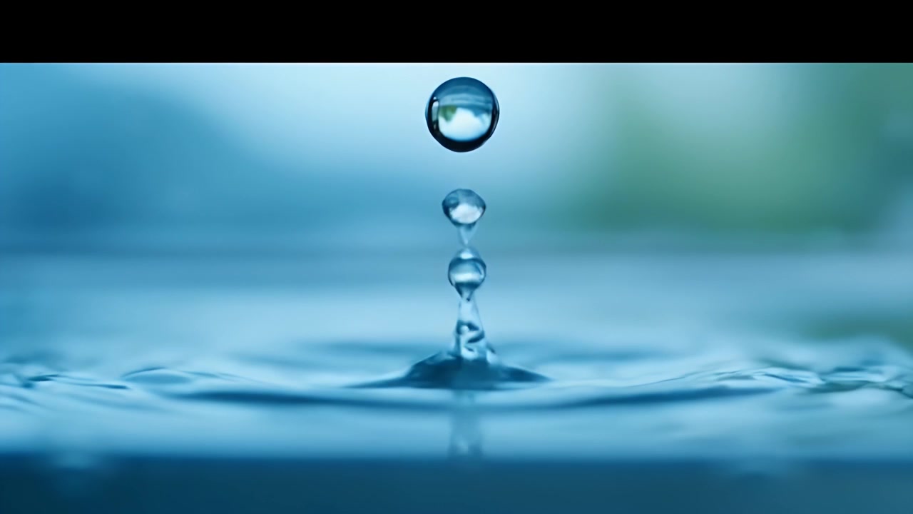 Macro Close-up of Water Droplets Falling into a Calm Pool