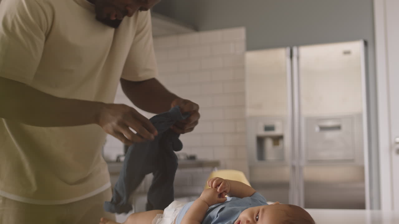 Single Father Dressing Baby