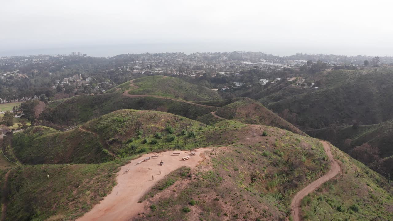 Aerial close-up panning shot of the Inspiration Point overlook at Will Rogers State Historic Park after the fire in Pacific Palisades, California. 4K