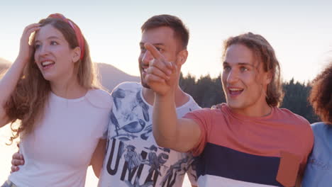 friends enjoying a sunset lake