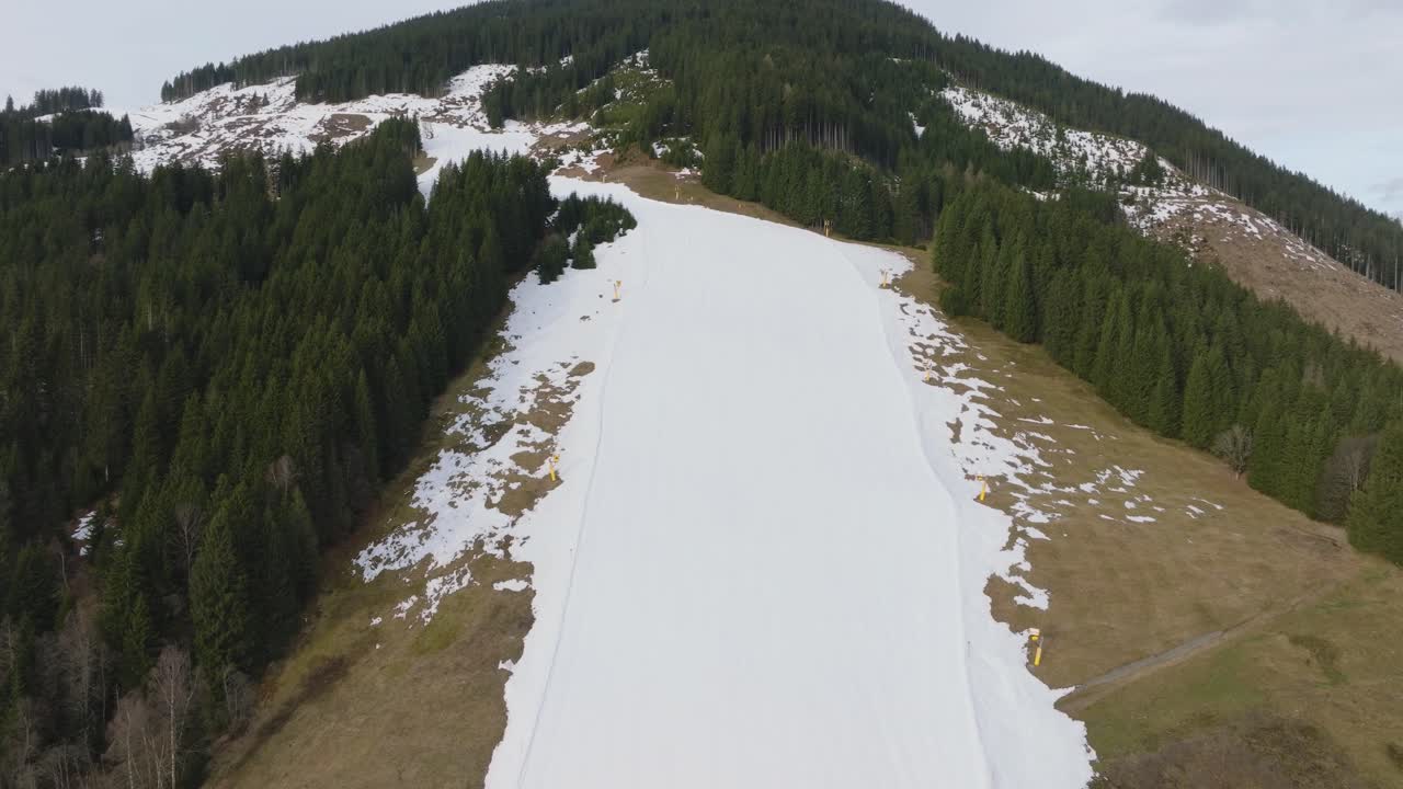 Saalbach-Hinterglemm ski resort with melting snow in the morning, aerial view