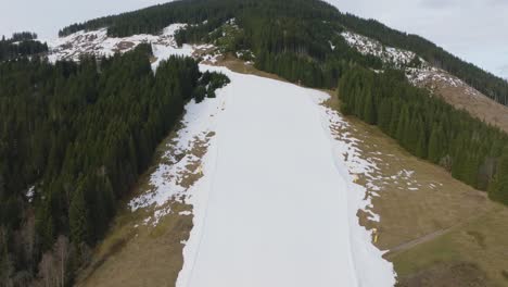 Saalbach-Hinterglemm-ski-resort-with-melting-snow-in-the-morning,-aerial-view