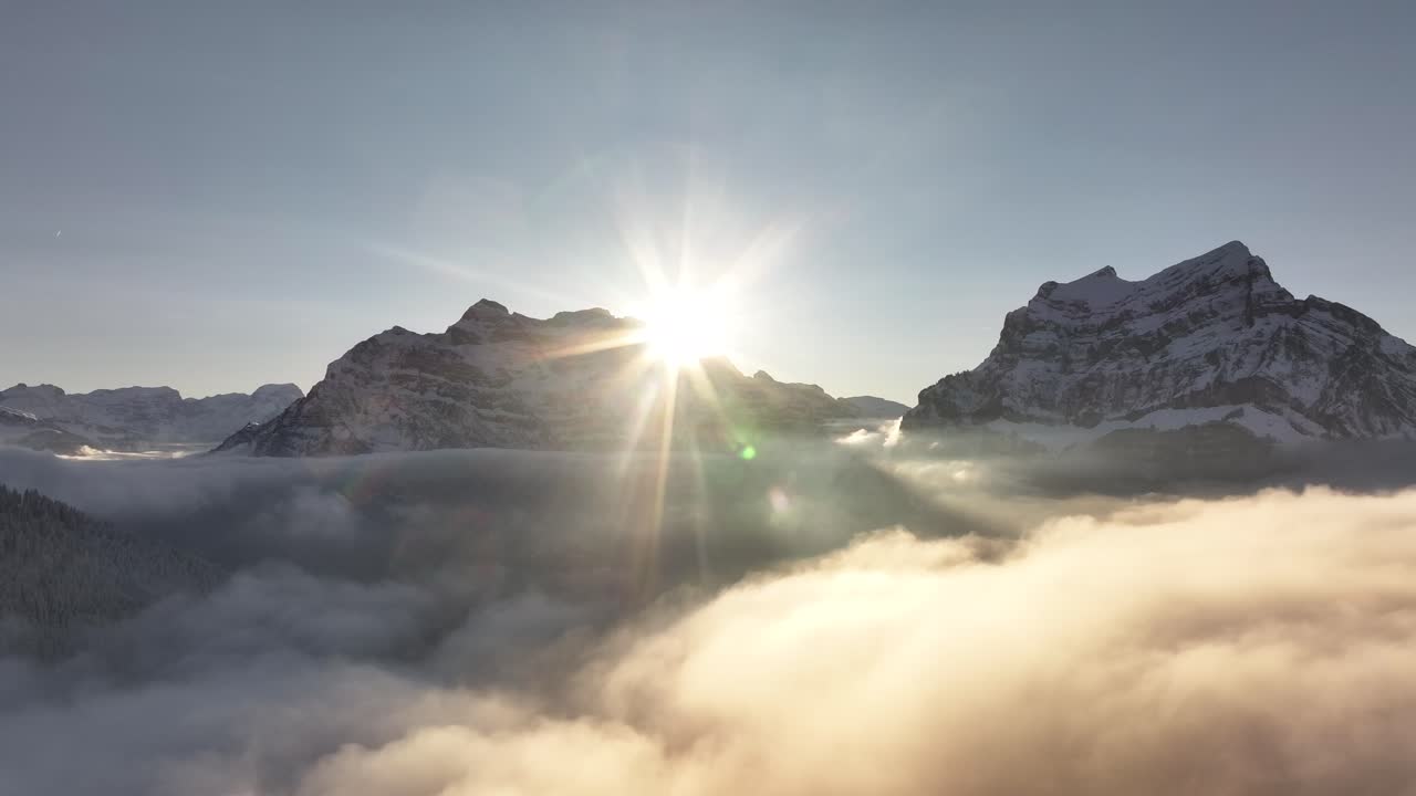 Golden sunrise over Rautispitz and Glärnisch peaks, Glarus Nord, Switzerland, above the clouds