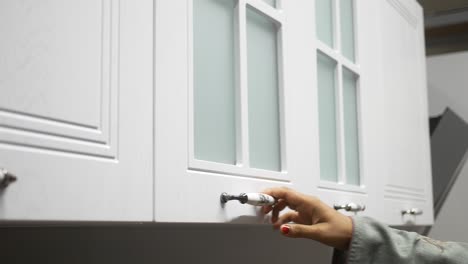 white kitchen cabinets with glass doors and handles