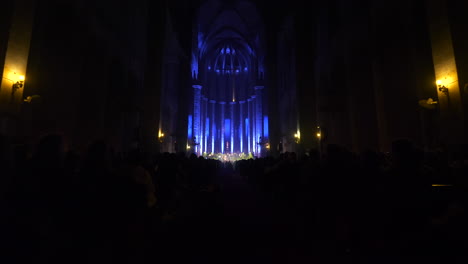 glowing stage of santa maria cathedral in barcelona during concert, dolly forward view