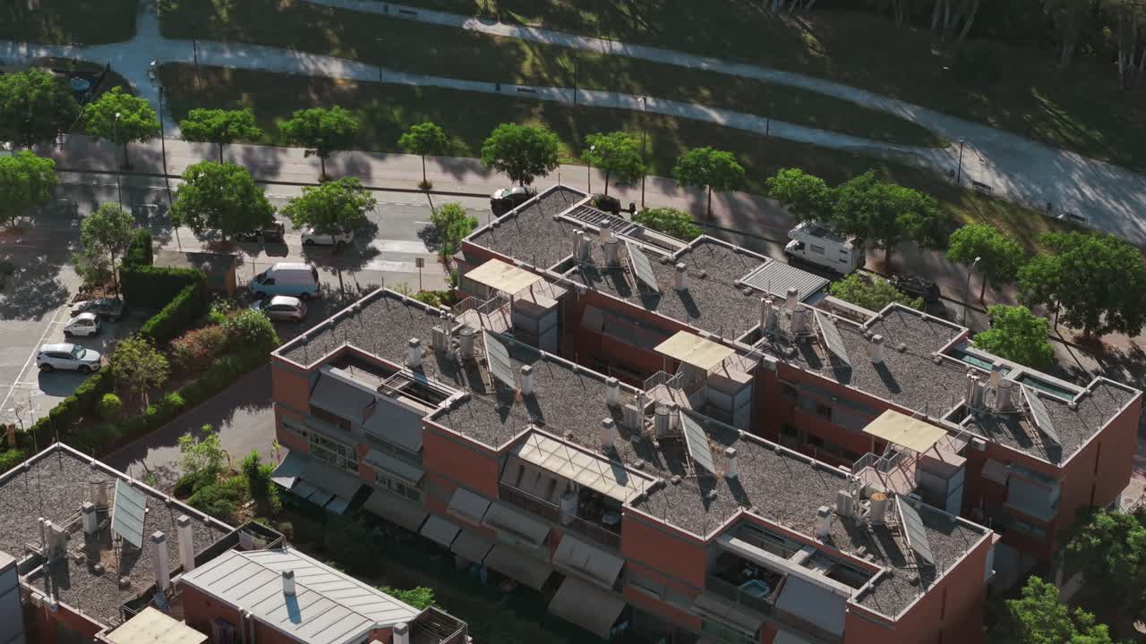 Top-down drone view of Soliva Este residential neighborhood with rooftops and trees, Málaga, Spain