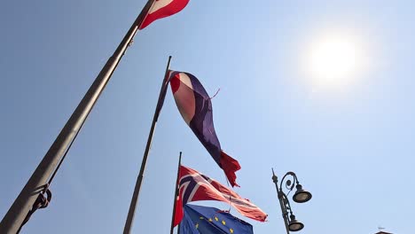 flags of various countries waving under the sun