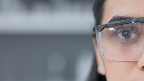 half face of a female biologist in safety glasses