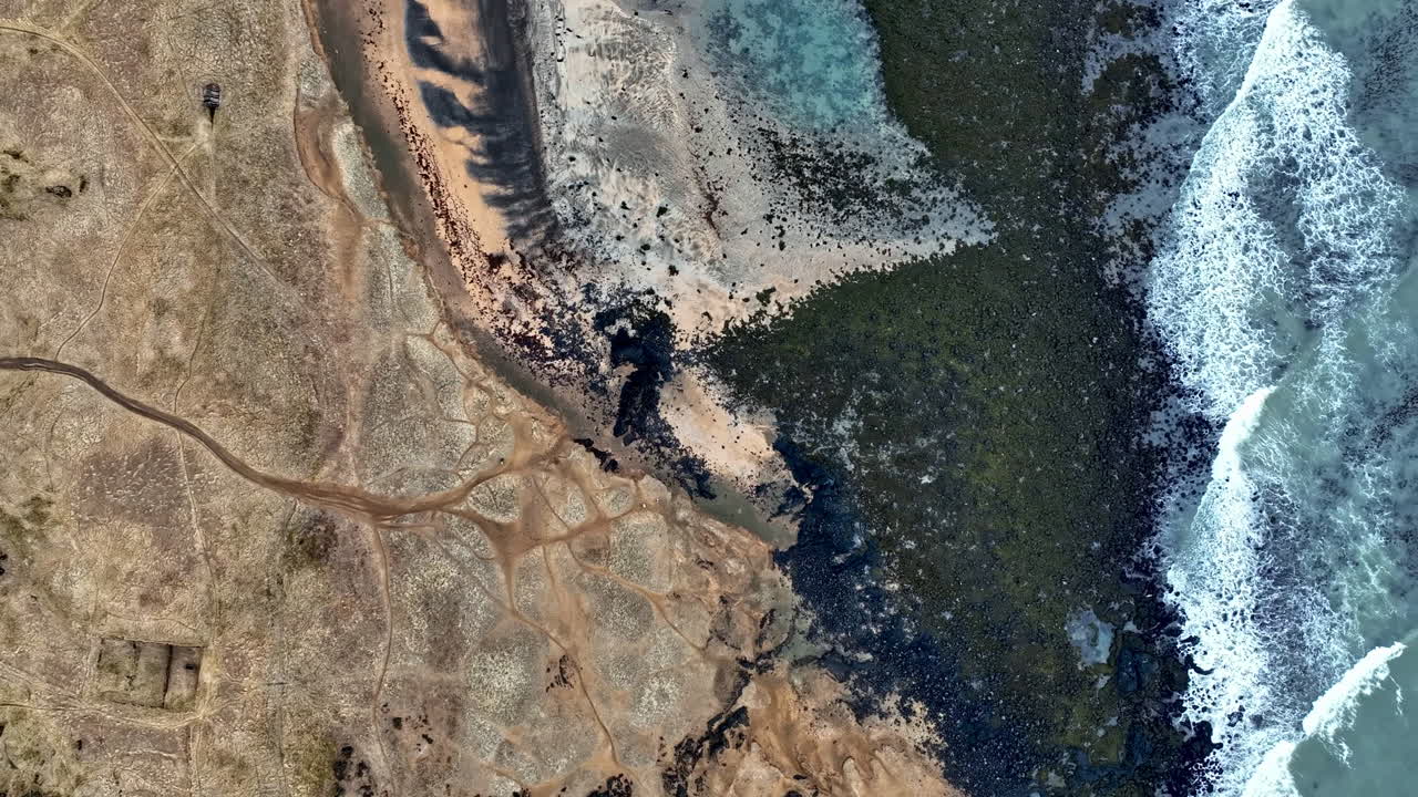 Birds eye aerial view over the coastline of Budahraun, sunny day in Iceland