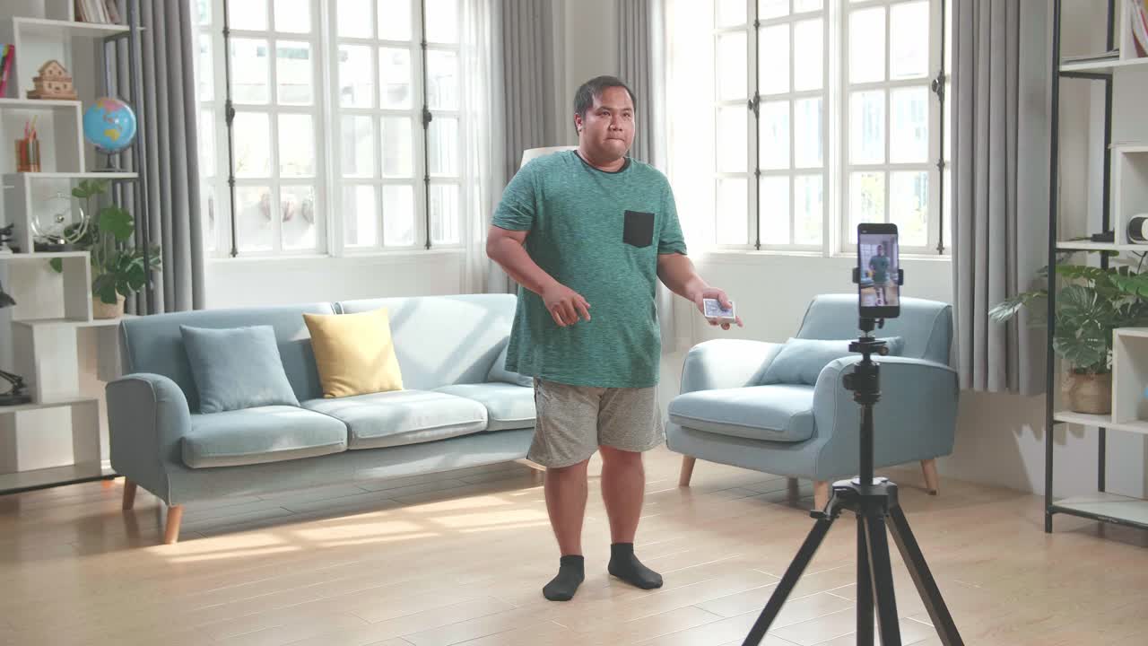 Asian Man Blogger Shoots Video Content For Social Networks By Smartphone Camera, Magician With Playing Cards