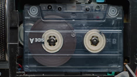 close-up of a cassette tape inside a tape player
