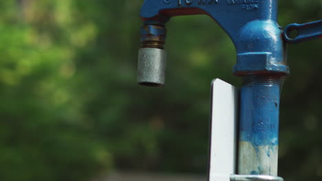 Close-up-view-of-a-drinking-water-faucet-in-a-park,-Campground-and-Creek,-Glacier-National-Park-Montana