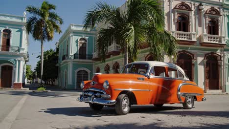 vintage orange car in a cuban colonial street