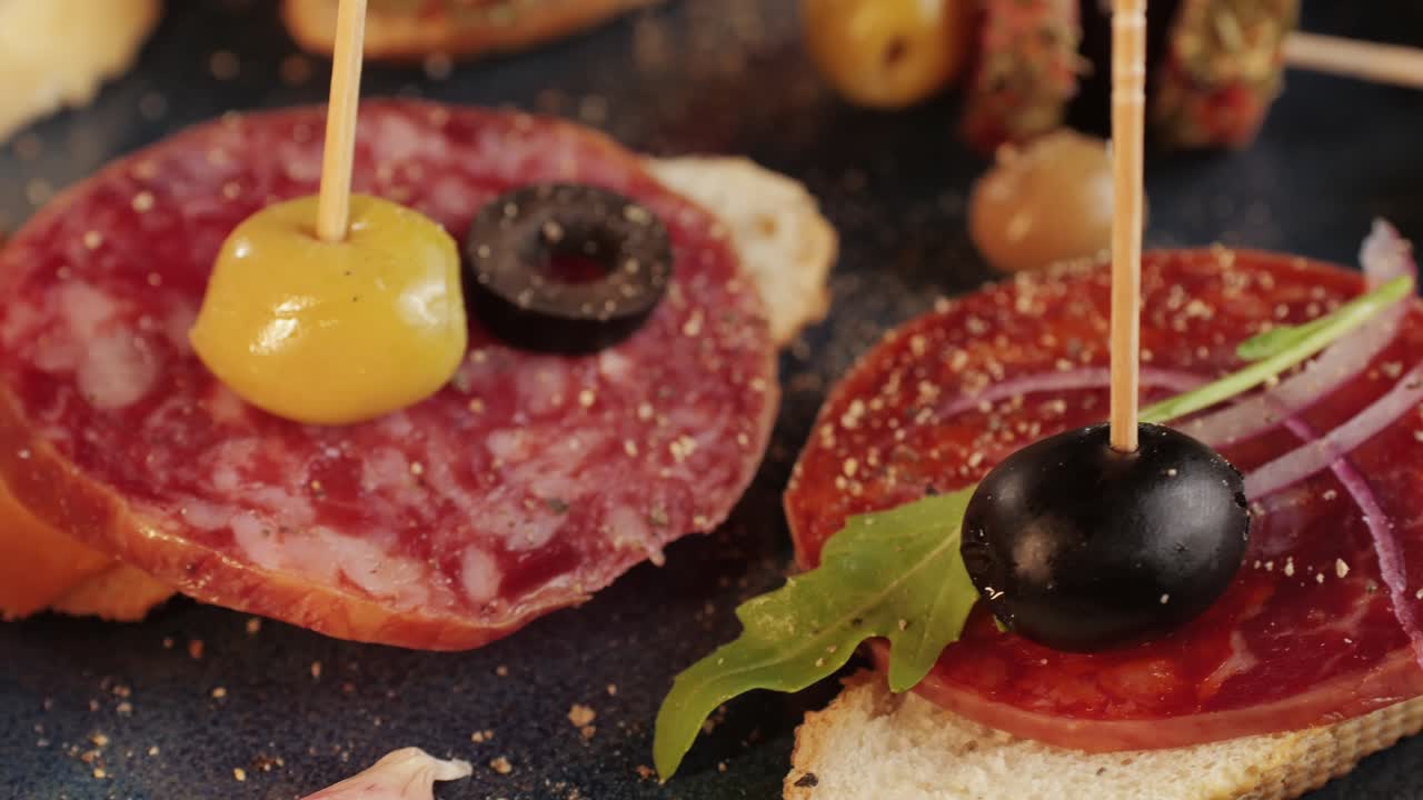 Mix of spanish pork sausages, Cutting board of appetizing catalonian snack - fuet, jamon, chorizo, olives, supermarket tapas food in spain, traditional cuisine.