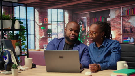 black freelancing couple doing a high five to celebrate their achievement