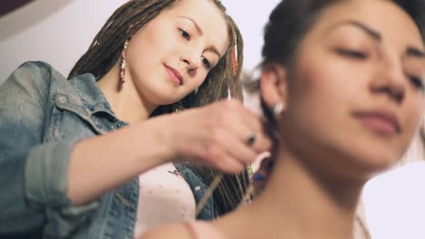 The-Hairdresser-doing-dreads-for-a-young-smiling-woman-in-the-hair-salon.-Shot-in-4k