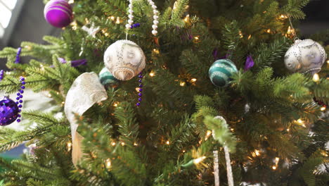 traditional christmas xmas tree decorated with ball ornaments beads lights purple blue silver white