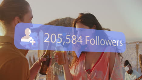 animation of speech bubble with increasing followers over biracial couple toasting drinks at beach