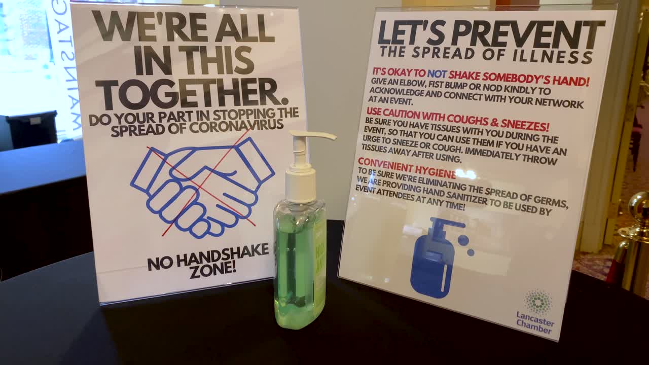 Coronavirus COVID-19 rules sign, no handshake, prevent spread of germs, hand santizer dispenser pump, social distancing, etiquette in pandemic era, we are in this together
