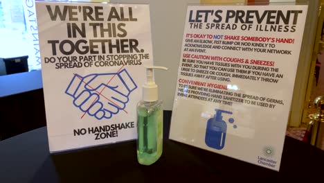 coronavirus covid-19 rules sign, no handshake, prevent spread of germs, hand santizer dispenser pump, social distancing, etiquette in pandemic era, we are in this together