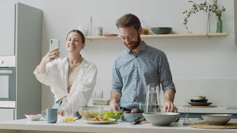 happy couple making a selfie photo in a modern kitchen