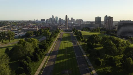 cinematic establishing shot of liberty memorial tower, kansas city skyline in background