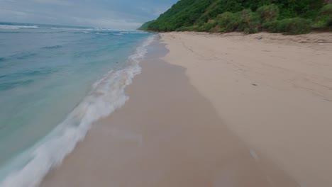 Fast-FPV-drone-low-cruising-shot-above-the-colorful-Nunggalan-beach-in-indonesia