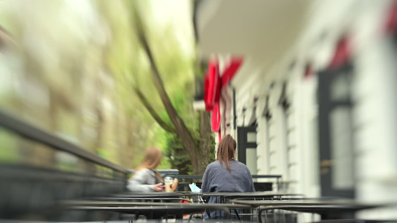 Focused view of women sitting at a cafe in daylight