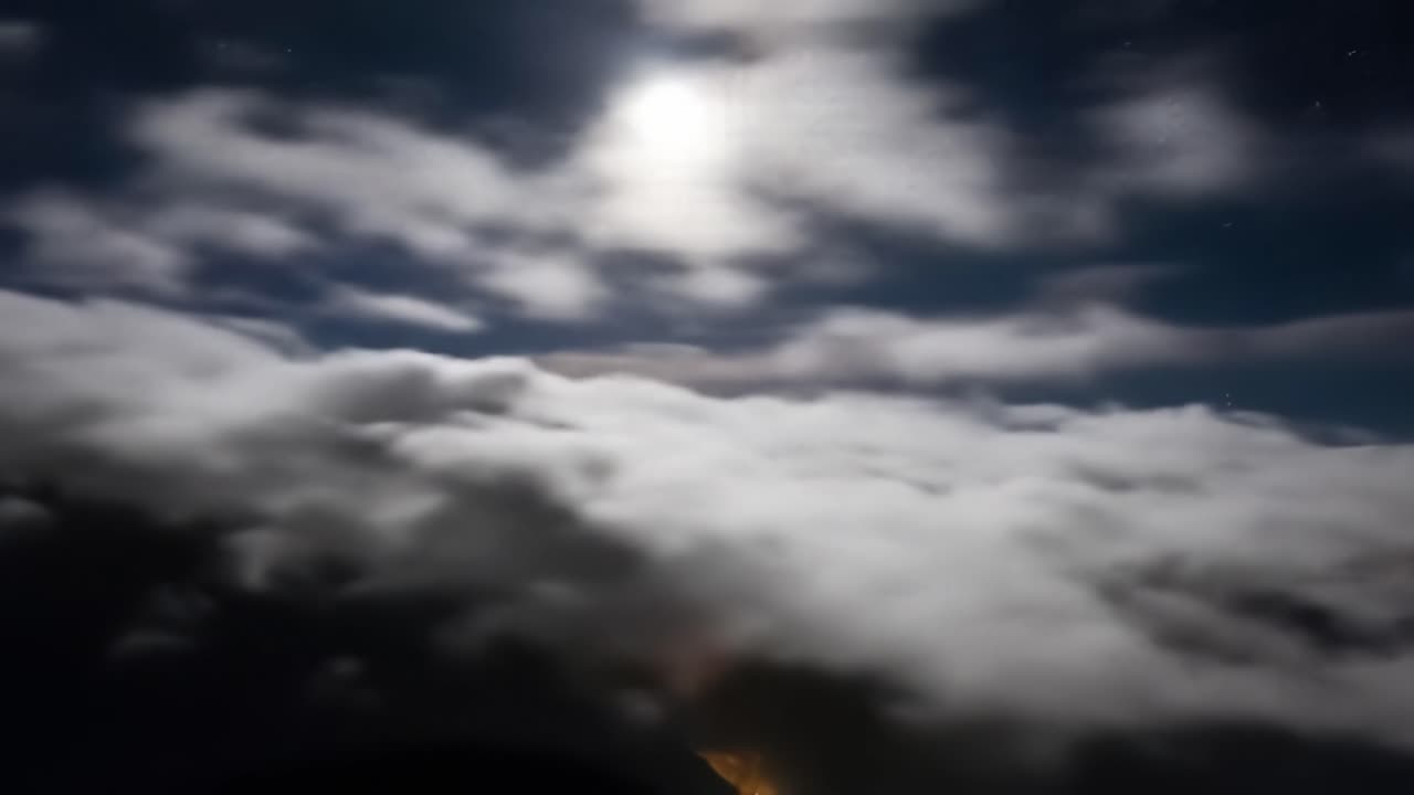 Moonlit Clouds over Mountain Peaks