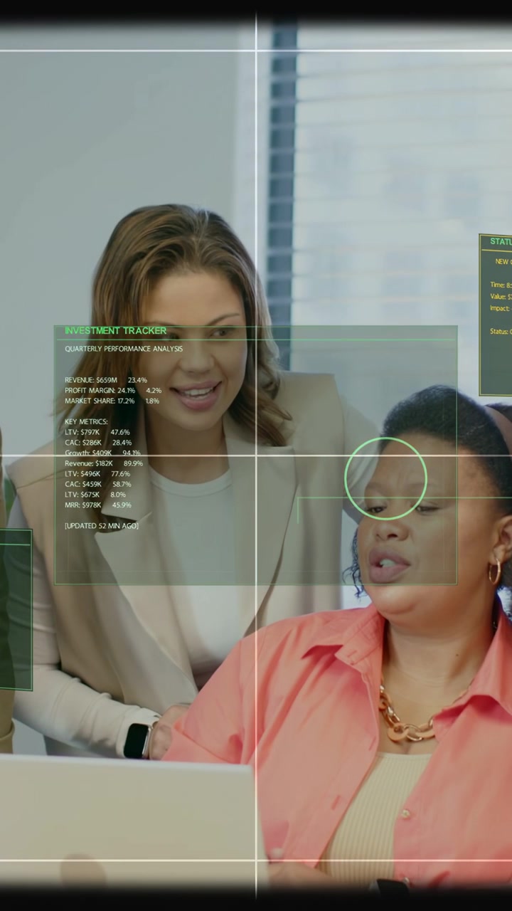 Vertical video: Seated analyst tapping laptop and explaining finance, HUD showing charts