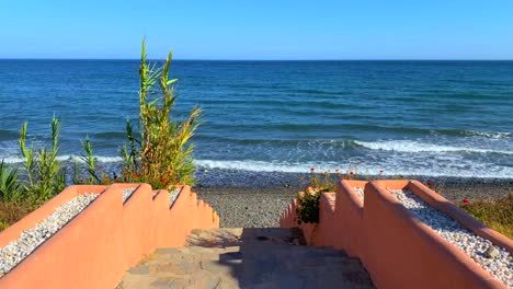 beautiful stairs to the ocean, steps leading down to the sea in marbella estepona, spain, 4k static shot