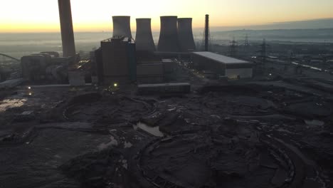 Fiddlers-Ferry-power-station-aerial-rising-view-partial-demolished-cooling-towers-wreckage-in-early-morning-sunrise