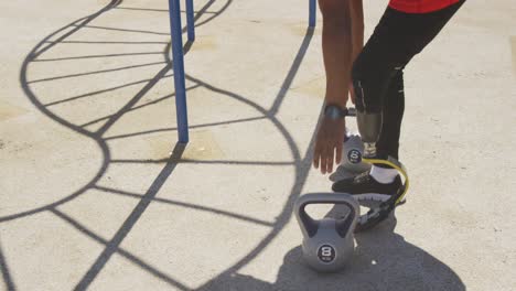 side view man with prosthetic leg exercising