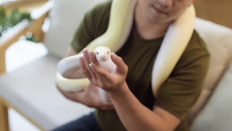 man with snake indoors