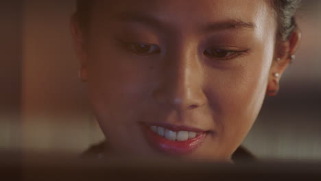 close up portrait beautiful asian woman using tablet computer watching movie laughing enjoying comedy entertainment relaxing at home