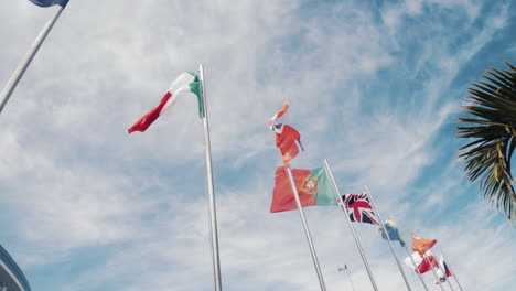 european and world flags flying on high flag poles