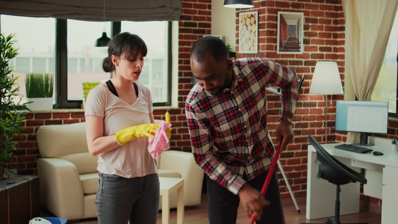 Diverse people vacuuming floors and cleaning furniture on shelves