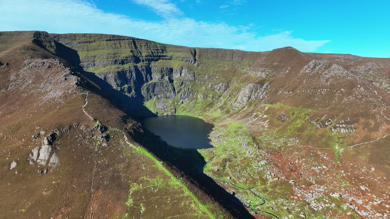 Irish epic Mountains drone view of Coumshingaun lake and hiking route above the lake Comeragh Mountains Waterford Ireland