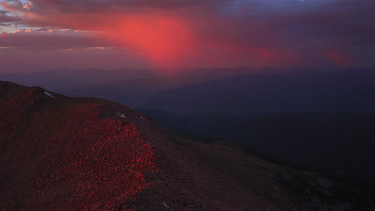 Notch Mountain shelter Mount of the Holy Cross Halo Ridge aerial drone Colorado 14er peak pink rain clouds golden hour vibrant sunset on Rocky Mountains Gore Sawatch Range Vail Minturn forward motion
