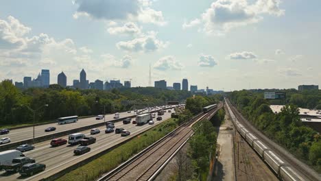 aerial view of skyline of atlanta in background and busy highway with passing train