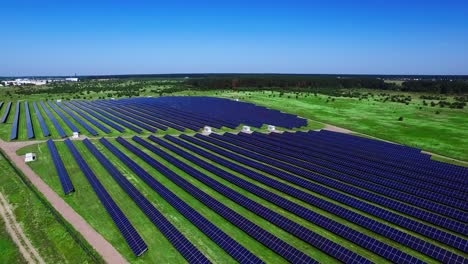 photovoltaic solar panels on green field at sunny day. aerial landscape