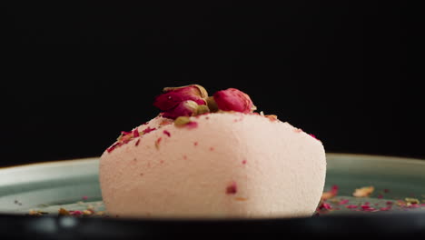 cutting a pink rose petal cake