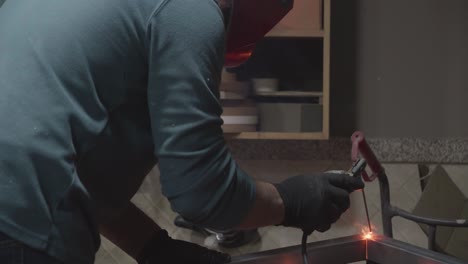 a man with a mask welding
