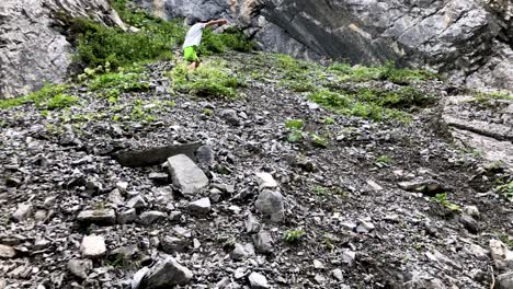 Cute-young-boy-having-struggle-climbing-mountain-full-of-rubble