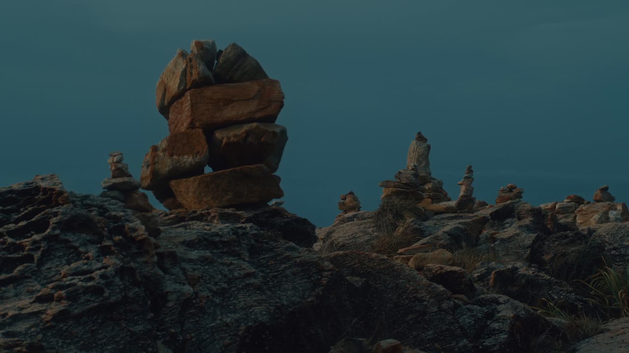Stone Cairn on Rocky Coastline at Sunrise/Sunset