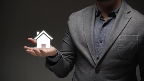 a house in hand palm of bussnies person. background for real estate property industry. new life. new home